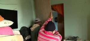 Casal improvisa instalações para amenizar o frio na casa danificada pelo ciclone — Foto: Reprodução/ NSC TV 